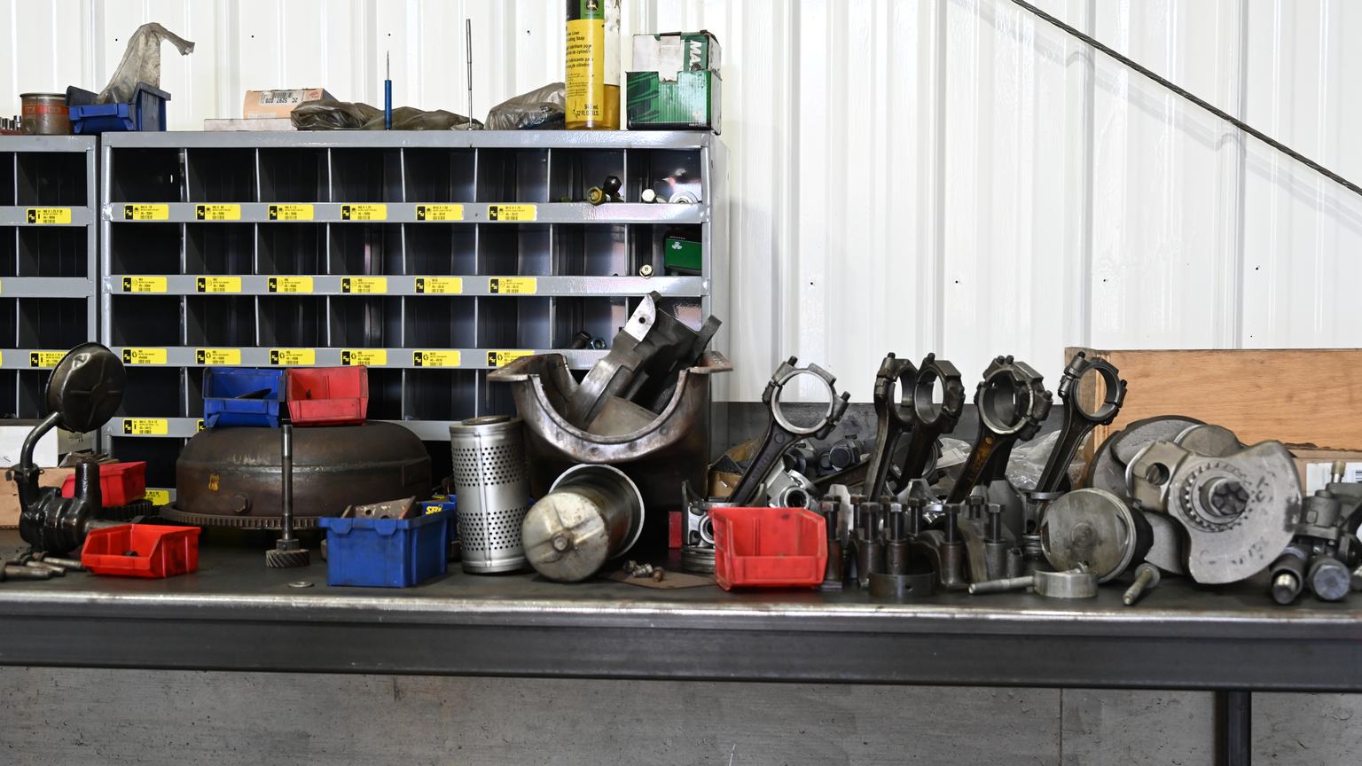 A workbench at PDM lined with engine parts waiting to be worked.