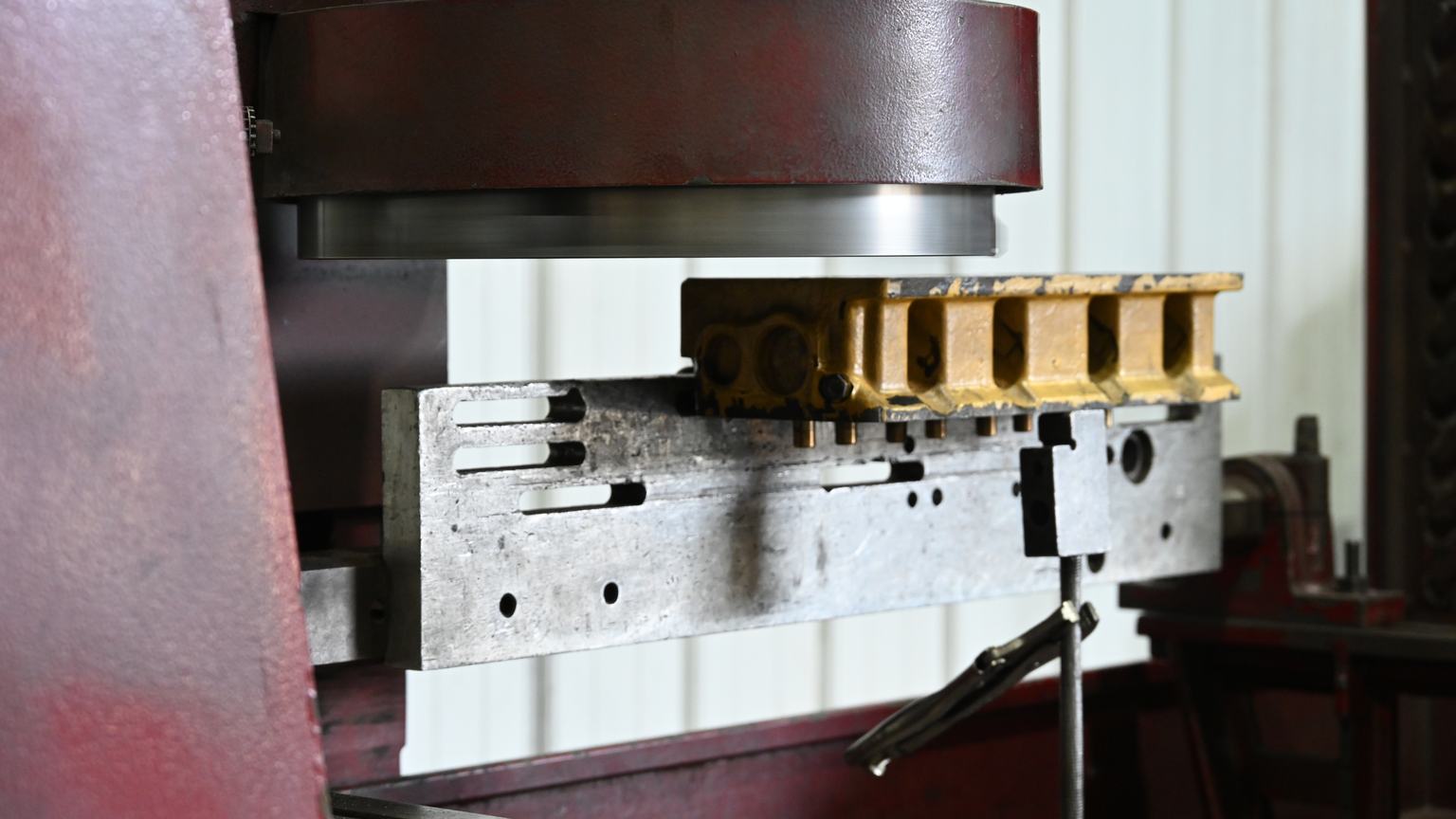 The rotary milling cutter head of PDM's surfacing machine above a cylinder head clamped in its fixture.